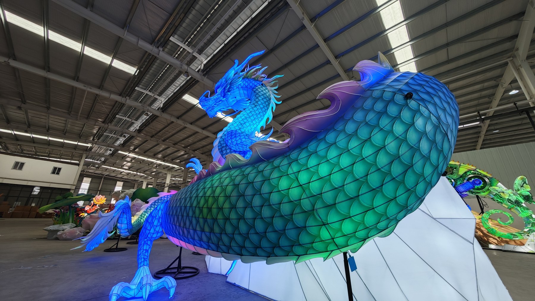 Close view of blue and turquoise scale patterns across a curved dragon lantern body
