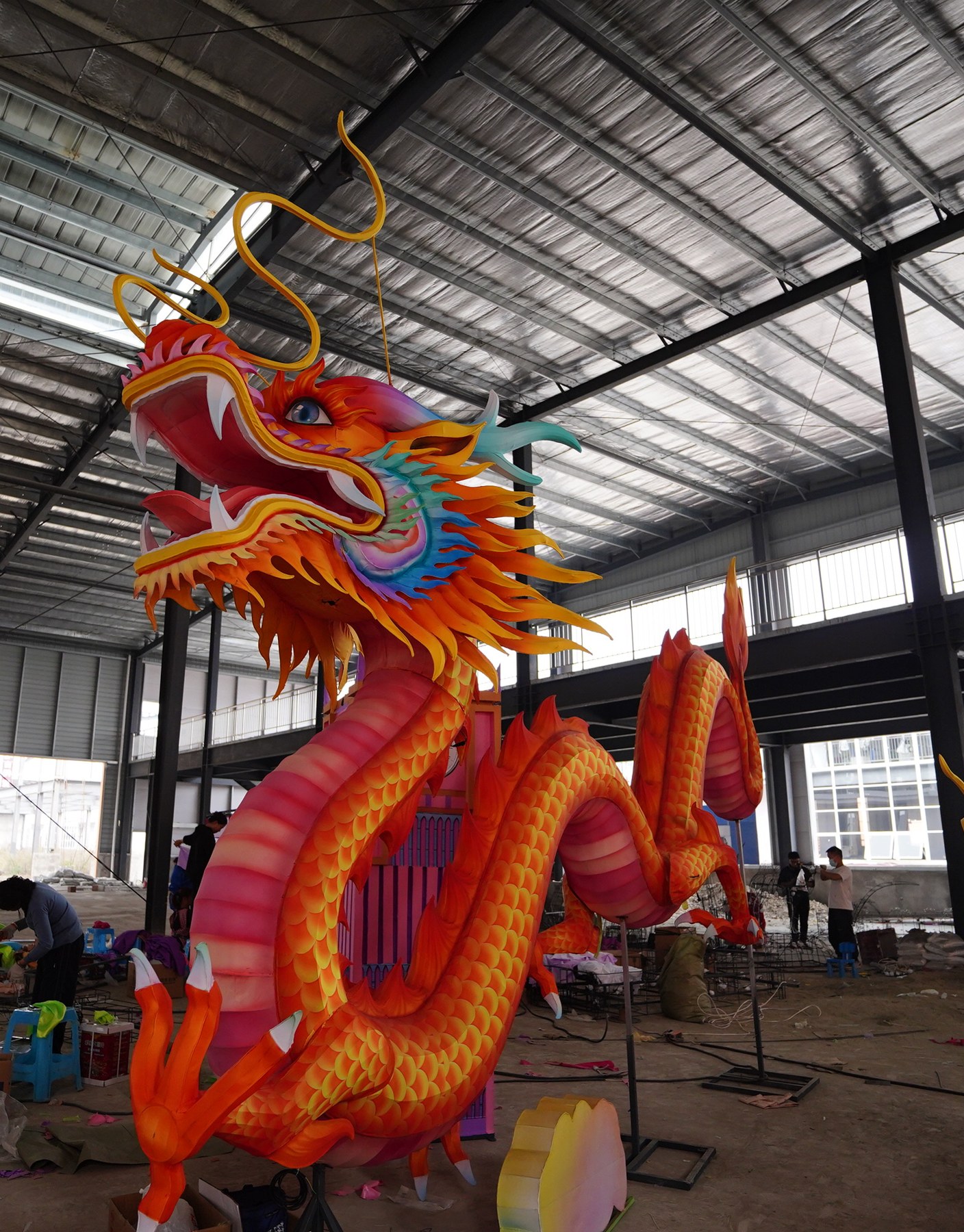 Red and gold Chinese dragon lantern with raised head, curling whiskers and an undulating body